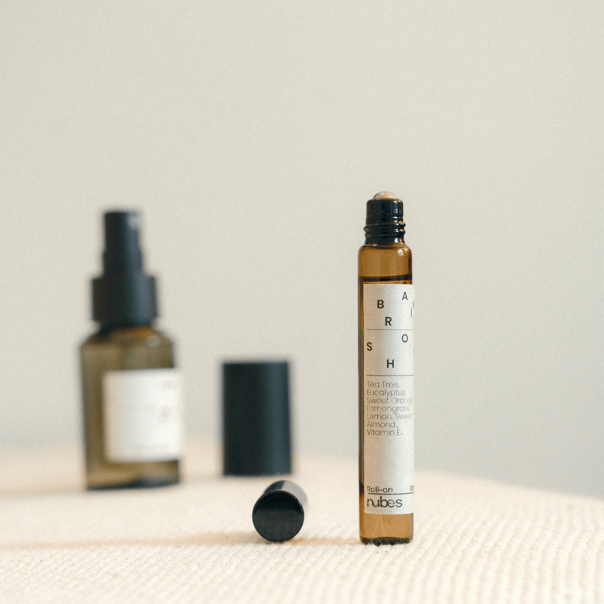 Roll-up bottle with a label on a textured surface