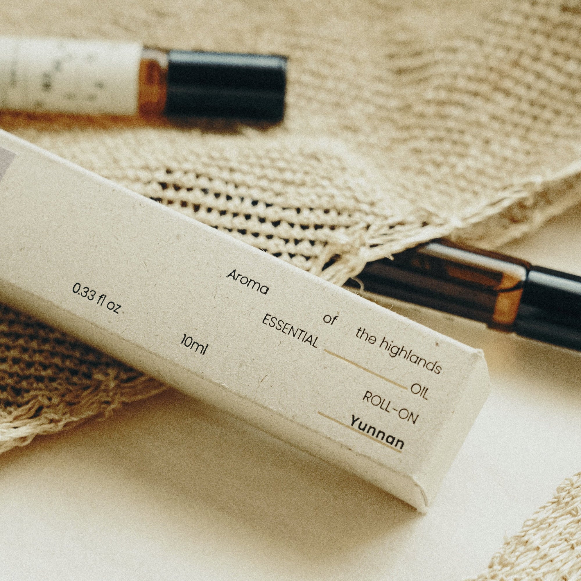 Essential oil roll-on bottle with label on a woven surface