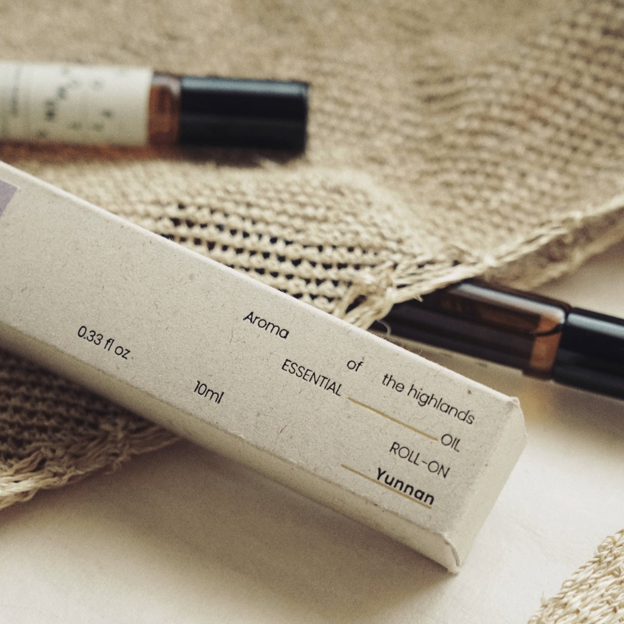 Close-up of Nubes roll-on essential oil packaging, highlighting its minimalist design and natural aesthetic.