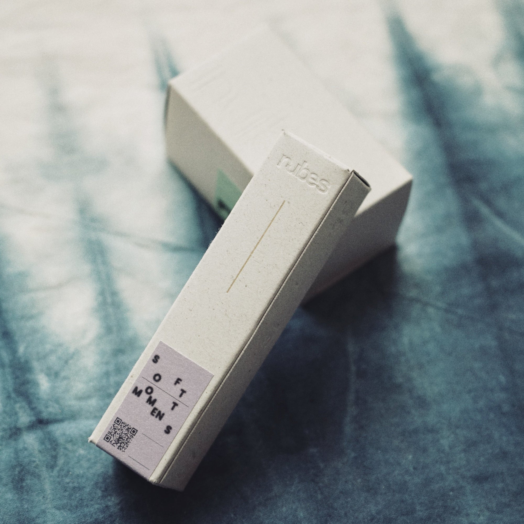 Two white boxes with text on a textured blue surface