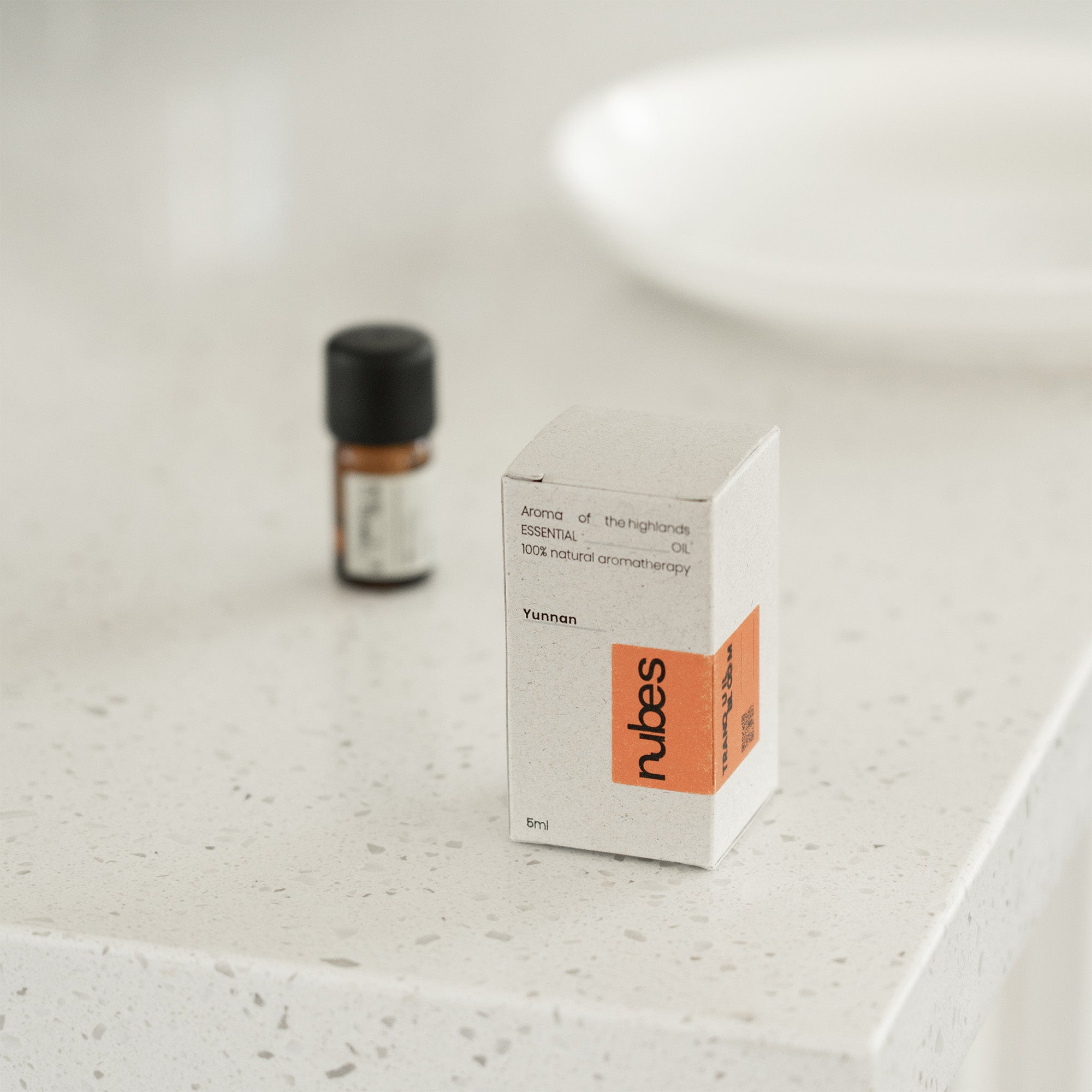 Nubes essential oil bottle and box on a light surface