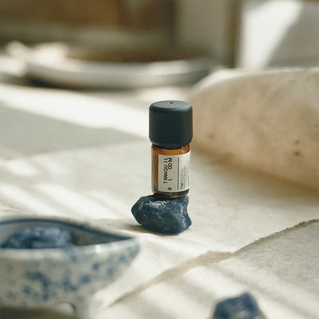 Small bottle of Frankincense oil on a stone surface with a blurred background