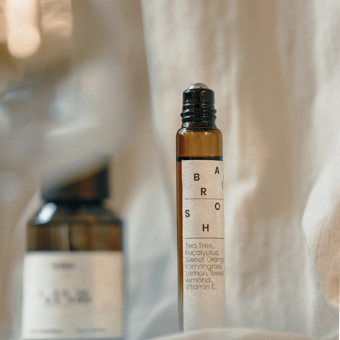 Roll-on bottle with a label on a soft, neutral background