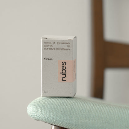 Rubes essential oil box on a light green surface with a blurred background
