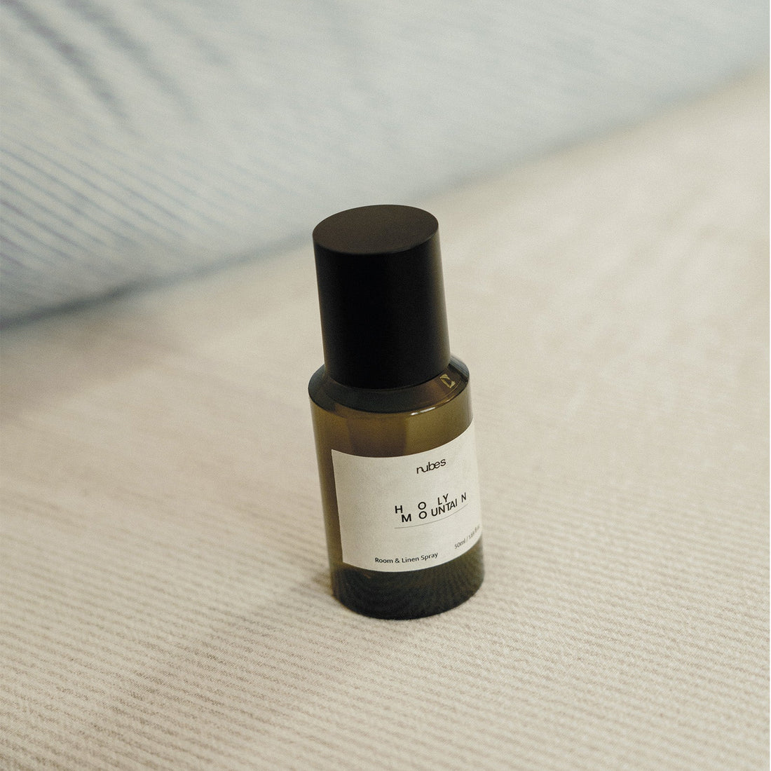 Spray bottle with a black cap on a textured surface