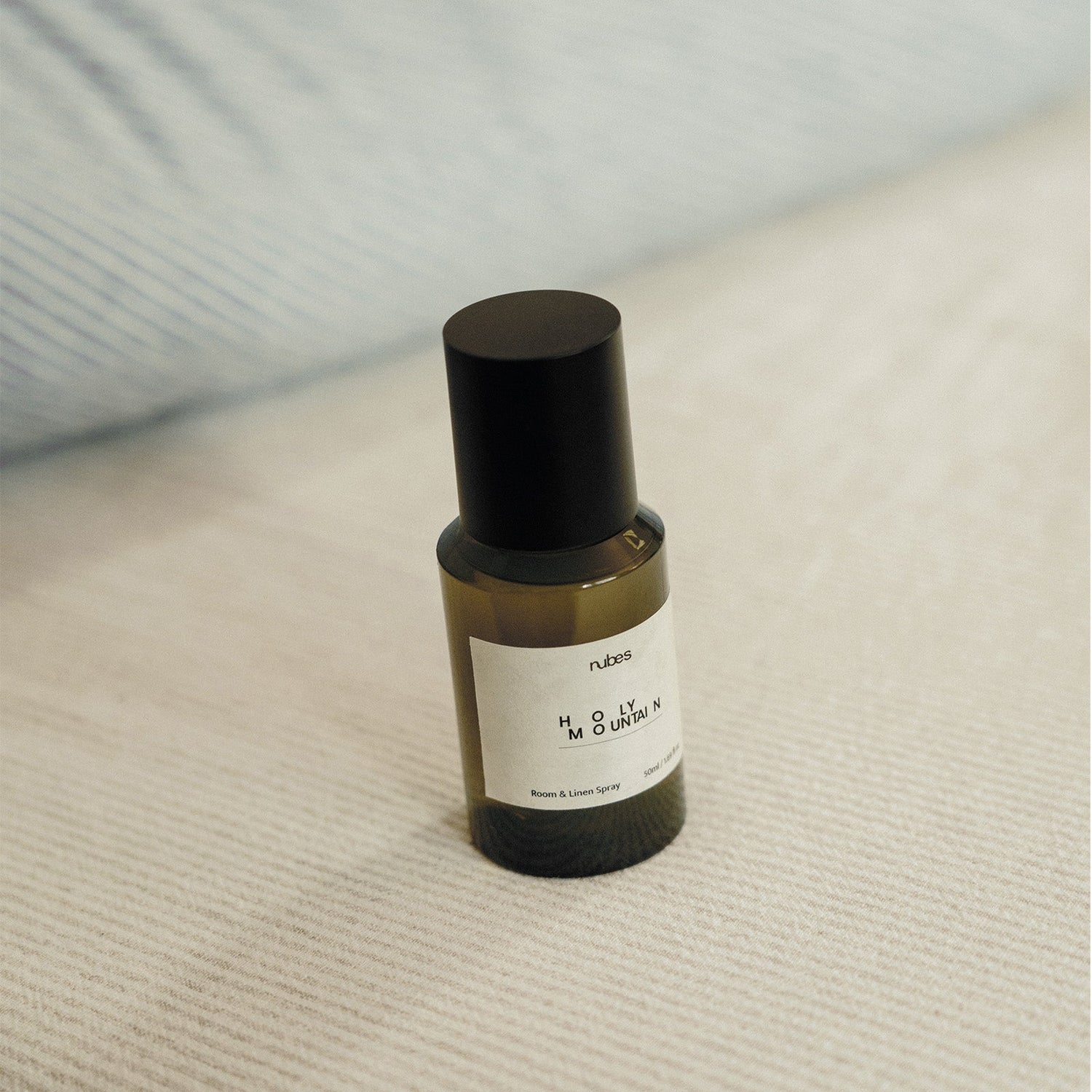 Spray bottle with a black cap on a textured surface