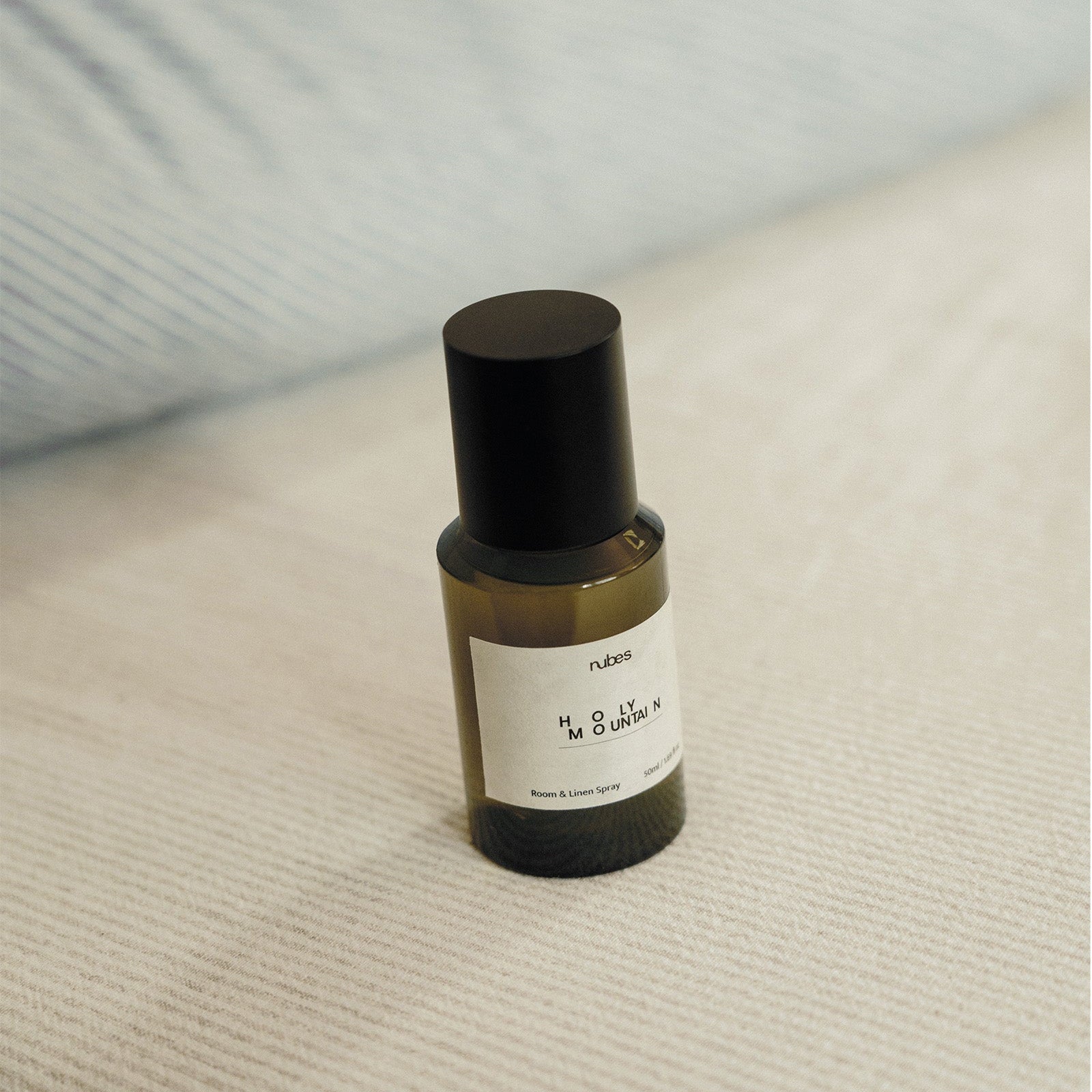 Spray bottle with a black cap on a textured surface