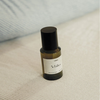 Spray bottle with a black cap on a textured surface