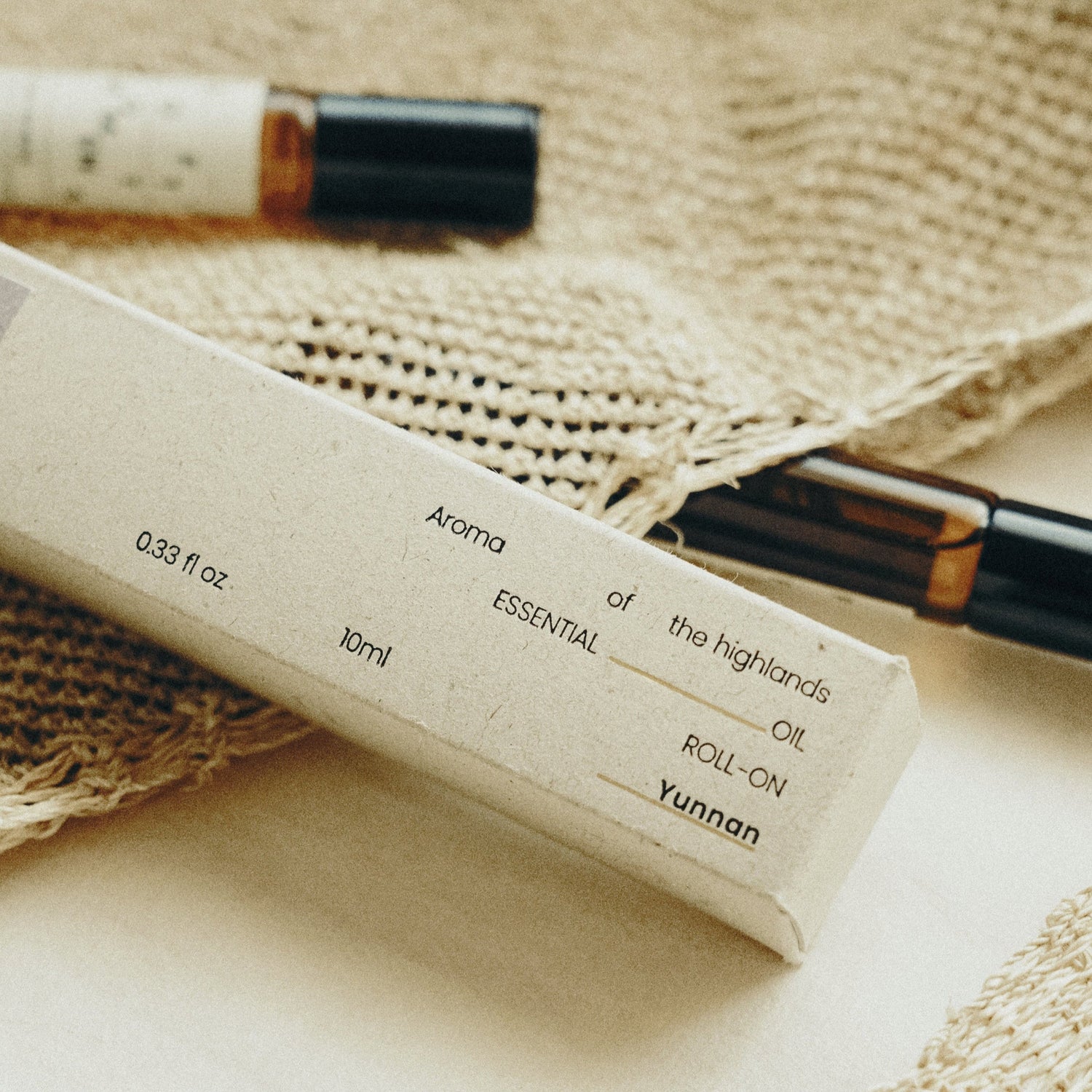 Essential oil roll-on bottle with label on a woven surface