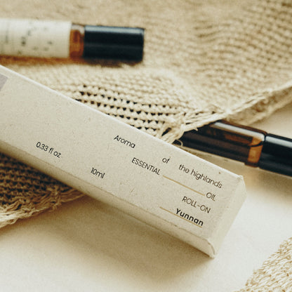 Essential oil roll-on bottle with label on a woven surface
