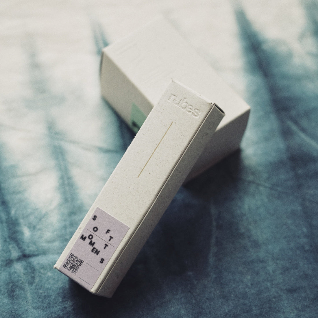 Two white boxes with text on a textured blue surface