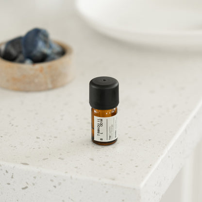Small bottle with a black cap on a light-colored surface
